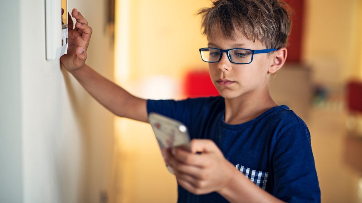 Child Using His Smart Phone To Sync With Smart Home Thermostat | Kid Friendly Smart Home