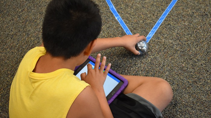 Native American Male Student Using Tablet For STEM Experiment