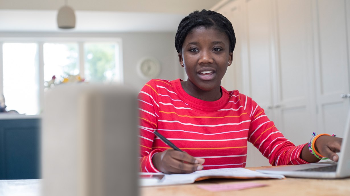 Teen Using Smart Speaker With Homework