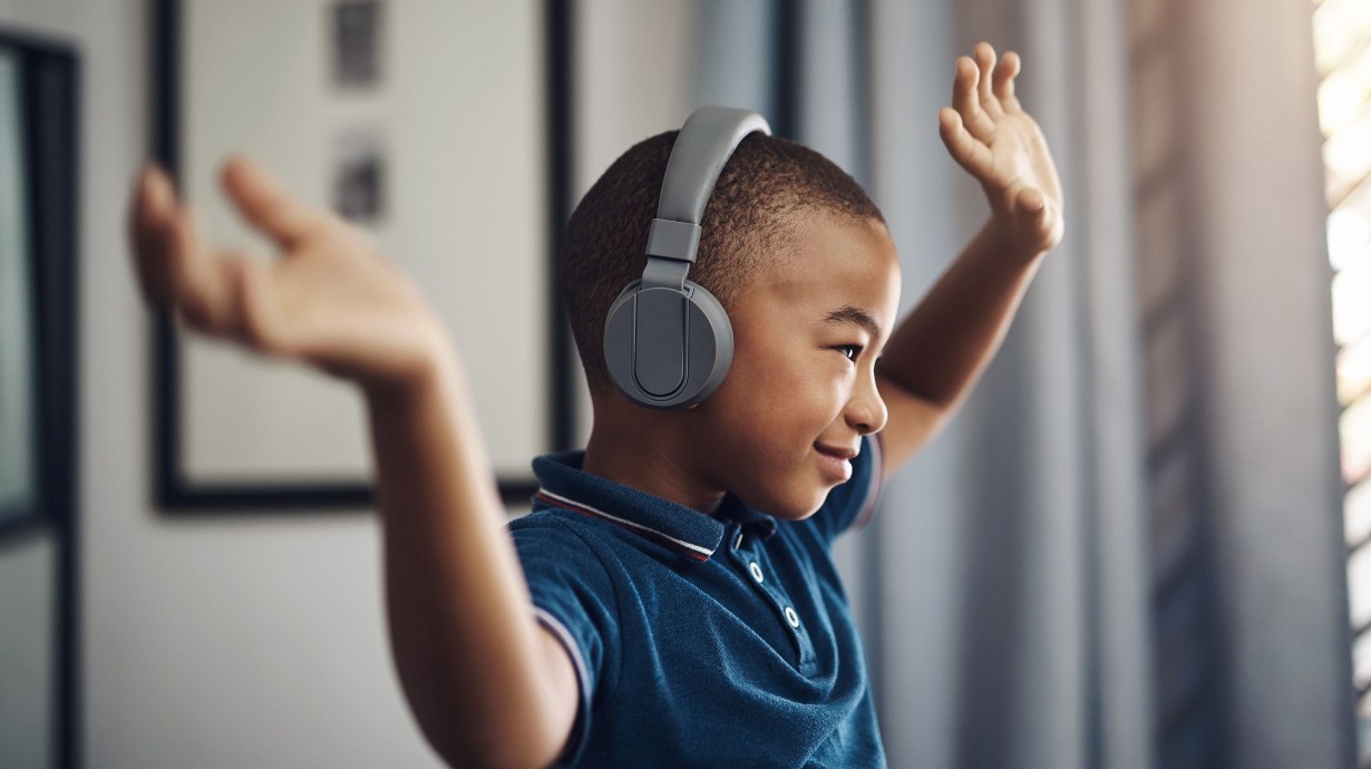 Child dancing and listening to music during reduced screen time