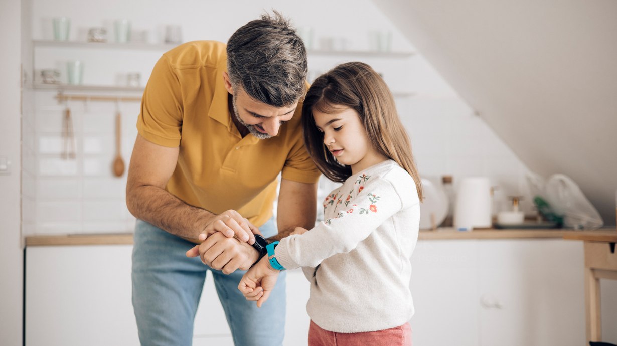 Father And Daughter Checking Smart Watches | Family Fitness