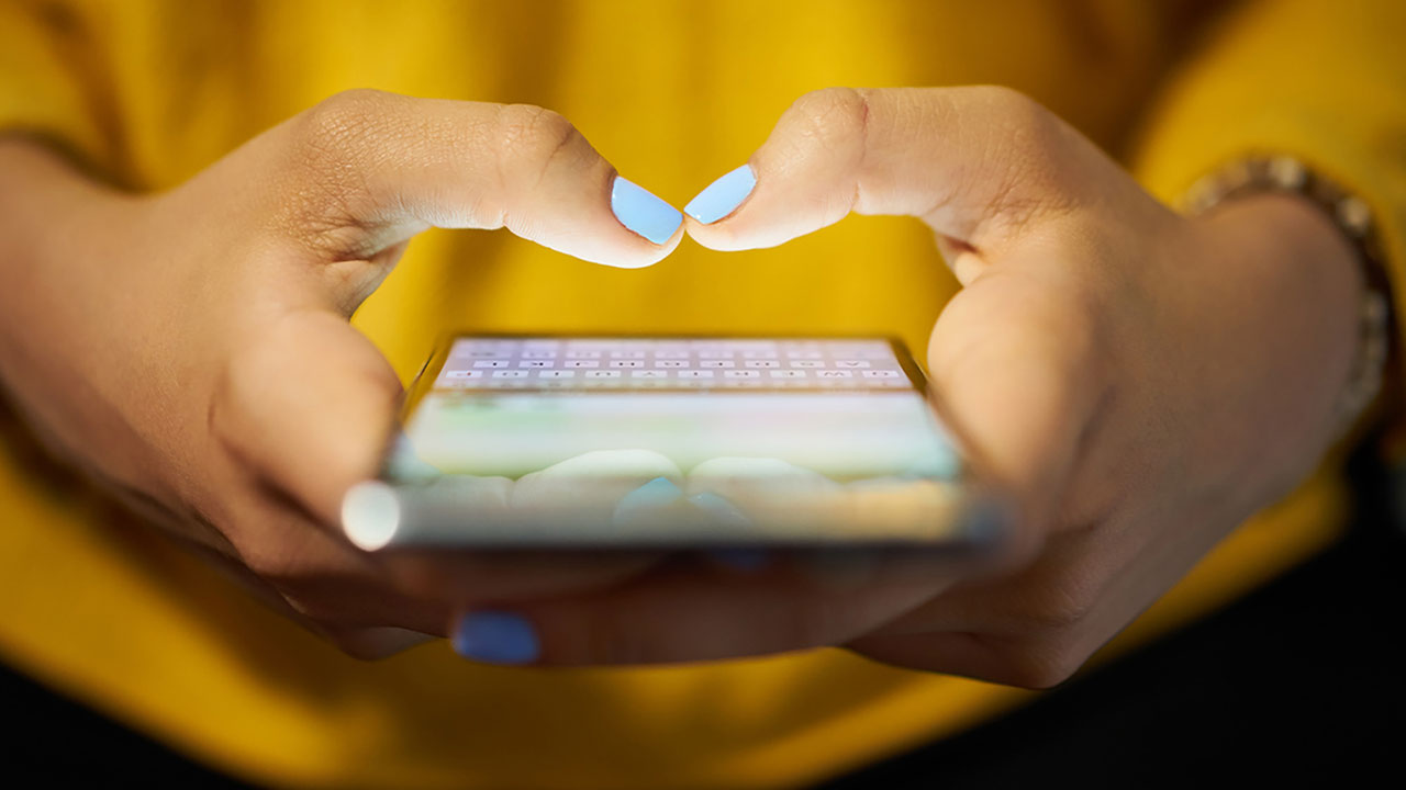 Woman with cell phone typing