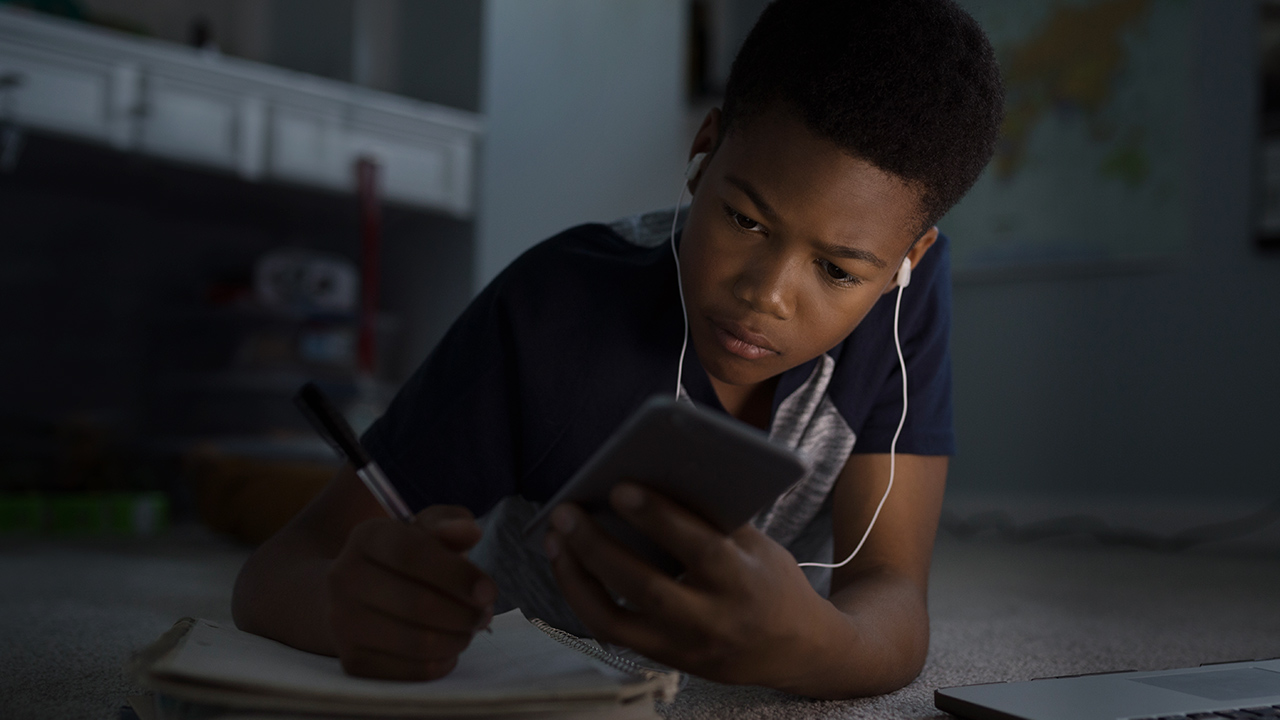 Image of a teenager on a phone.