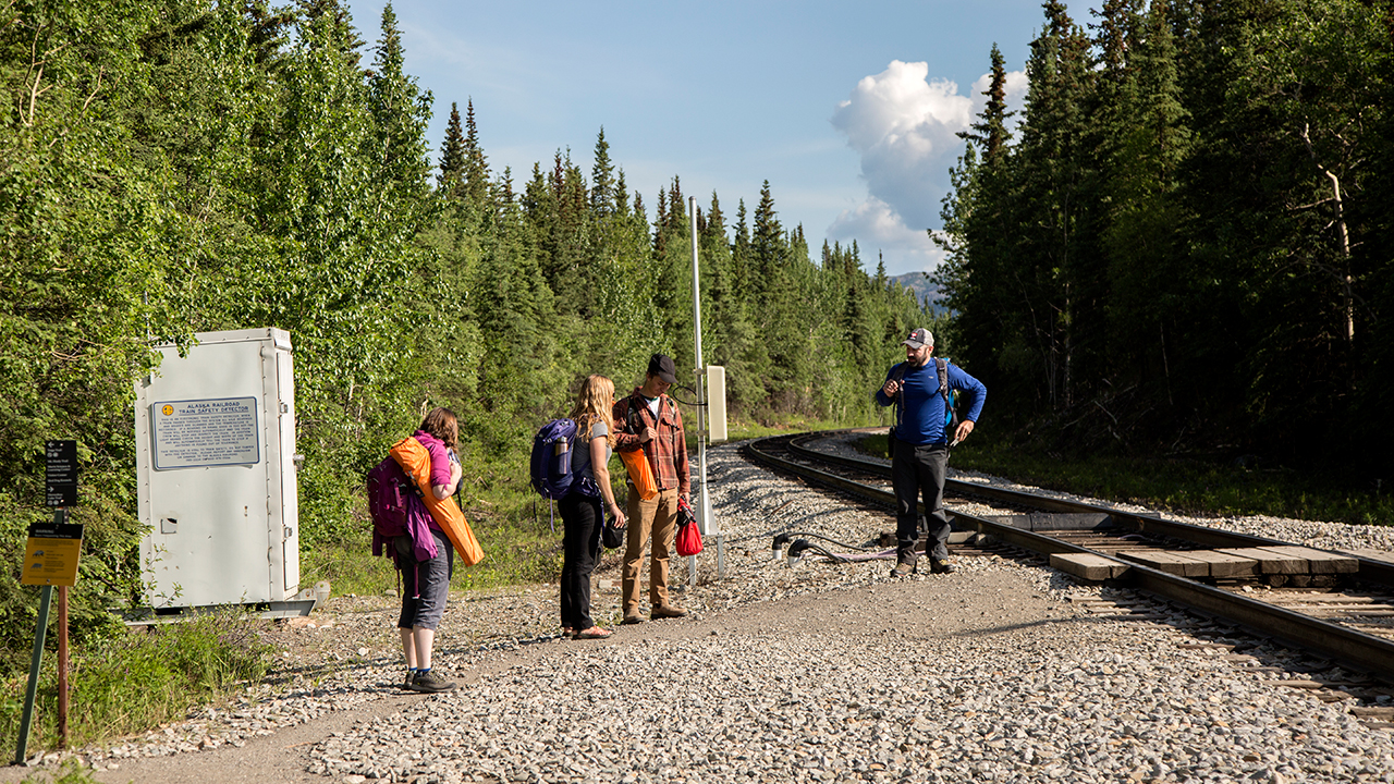 People by train tracks