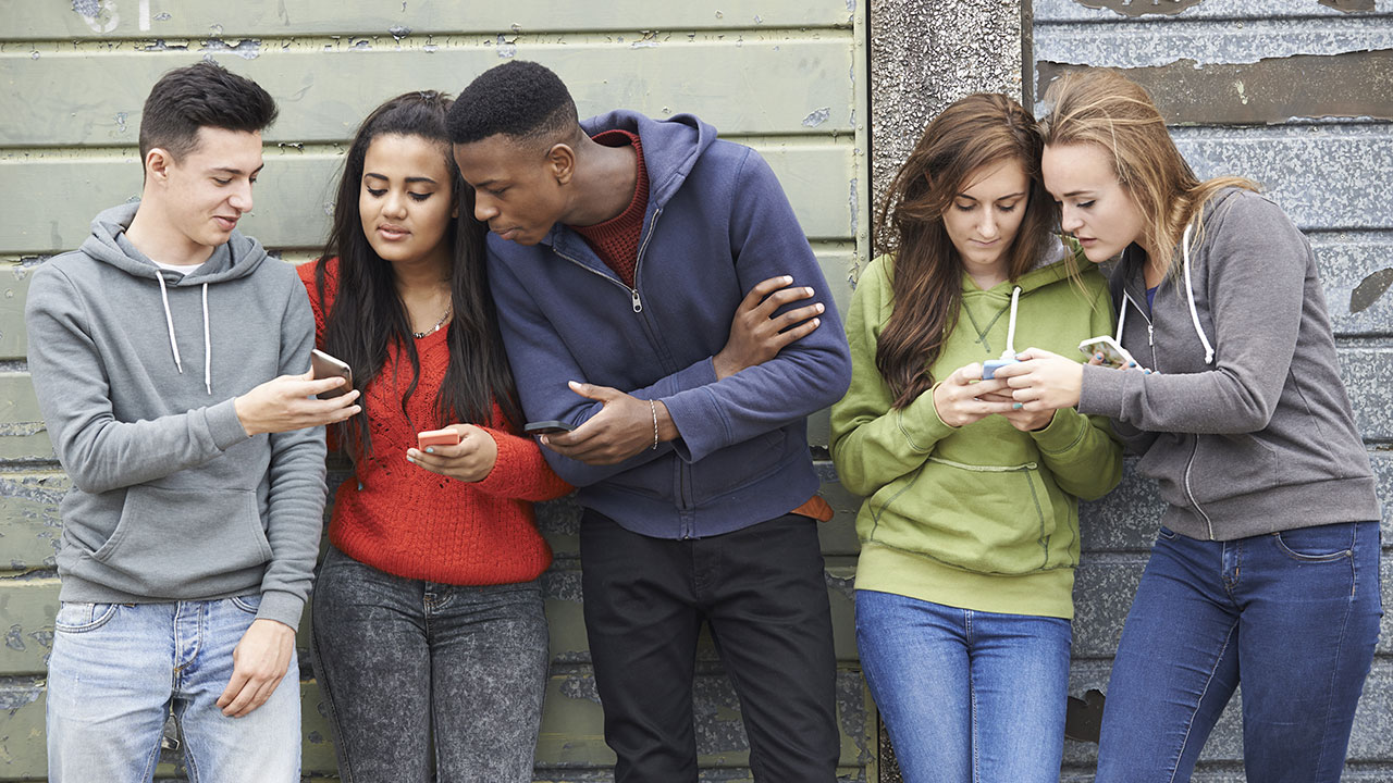 Teenagers with cell phones