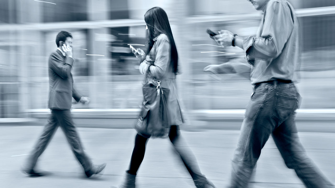 Crowd walking with their cell phones