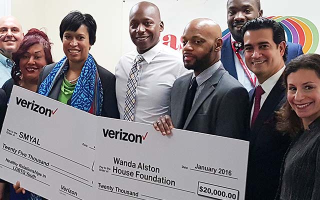 Washington, DC mayor Muriel Bowser, second from left, and Mario Acosta-Velez, second from right, present grant checks to Sultan Shakir from SMYAL and Ken Pettigrew from Wanda Alston House in Washington, DC. 