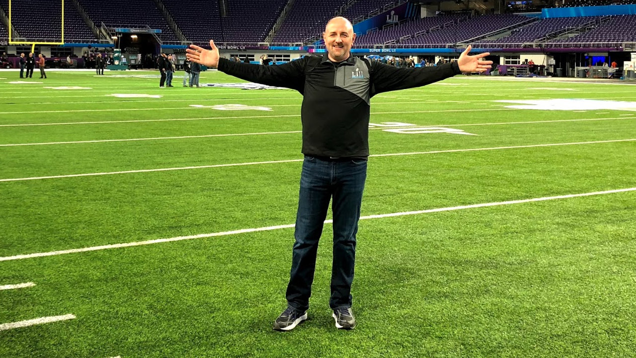 Image of Brian Mecum standing on the field at US Bank stadium.