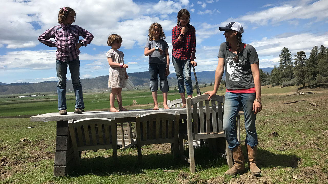 Girls stand on a picnic table