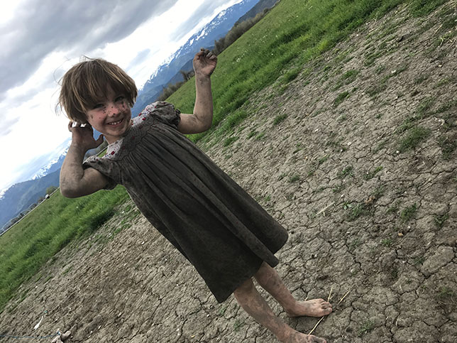 Tiny Tess playing in a mud puddle 