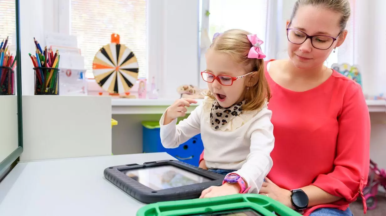 Child Communicating With Mother Using AAC Technology