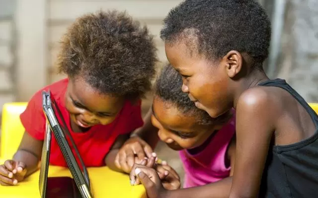 African-American children playing with tablet