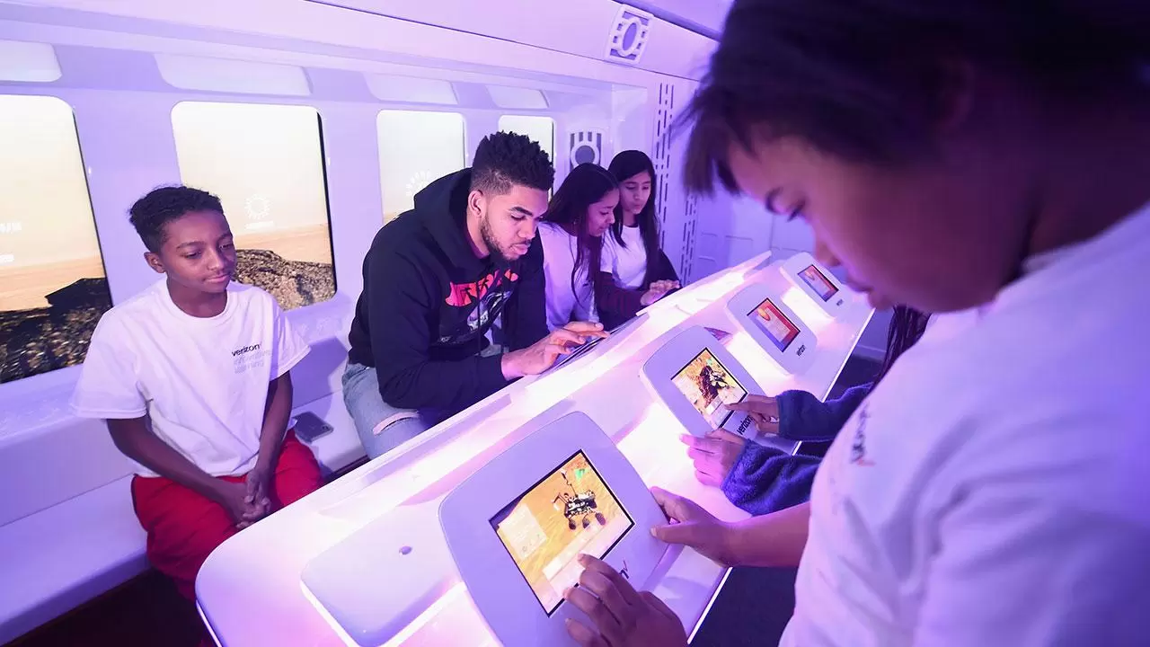 Karl-Anthony Towns  with kids in explorer lounge