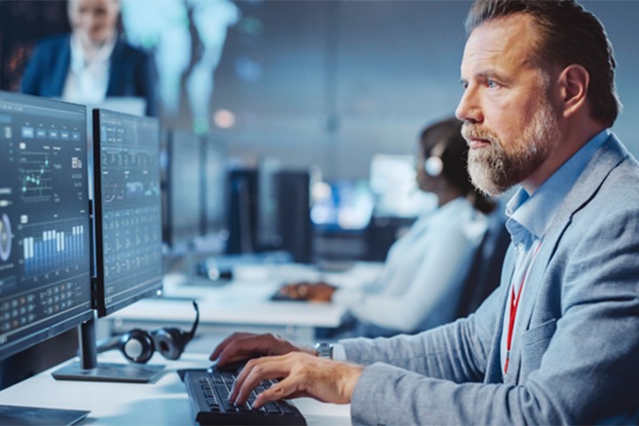 Man reviewing cybersecurity details on a desktop computer