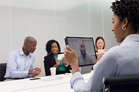 Group of professionals video conferencing in a meeting room