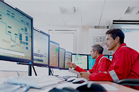 Two operational monitors reviewing data on desktop computers