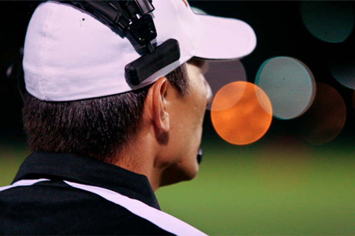 Football coach standing on football field