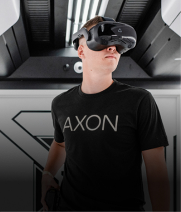 Man wearing VR goggles and an Axon T-Shirt 