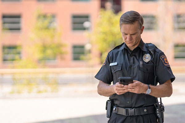 male police officer using a digital device