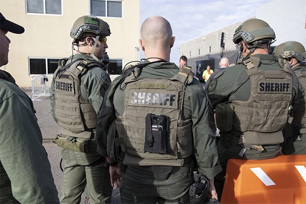 A group of sheriff officers in S.W.A.T. gear.