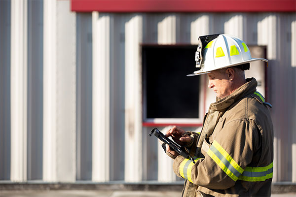 Male firefighter using a tablet