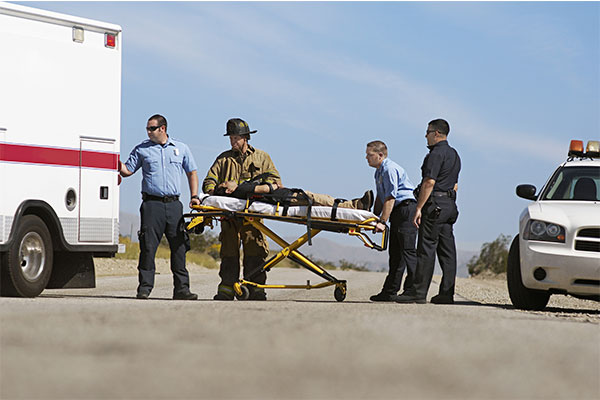 First responders load a stretcher into an ambulance