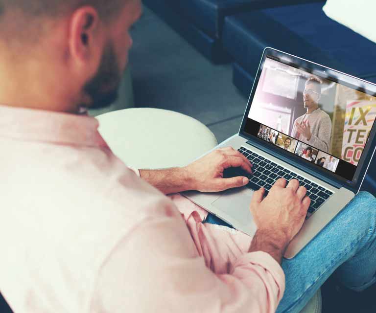 Man joining a video conference on his laptop