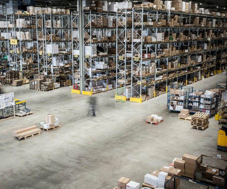 inside a production warehouse with boxes on shelves