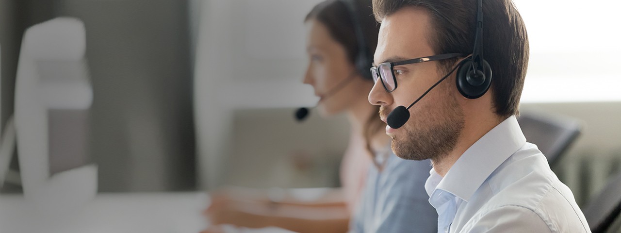 Call center representative consulting client while working in office