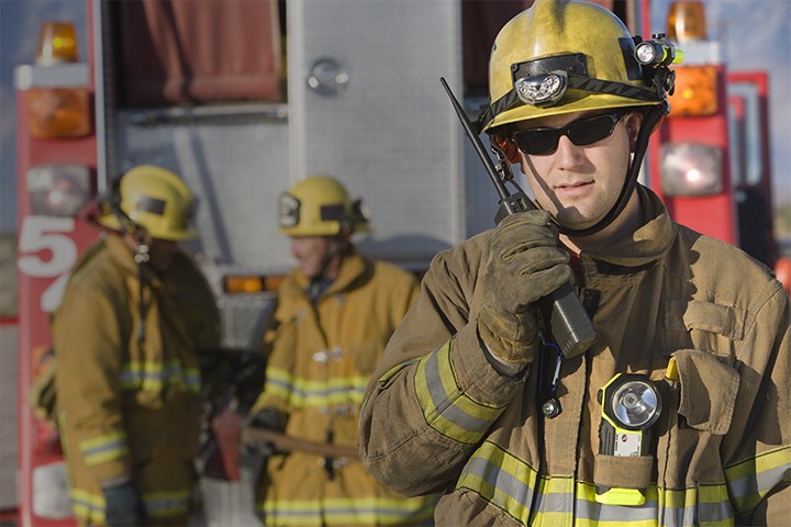 Group of firefighters on-scene communicating with each other
