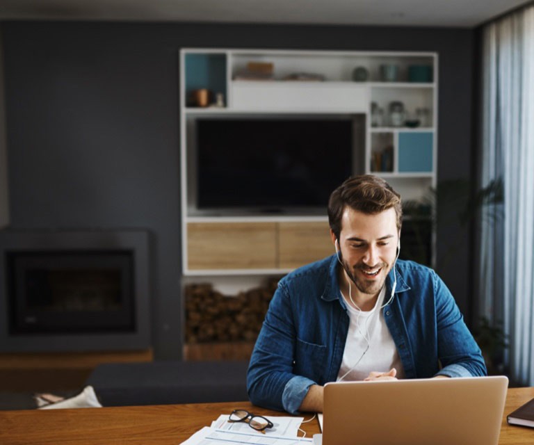 Man sitting in front of the laptop smiling