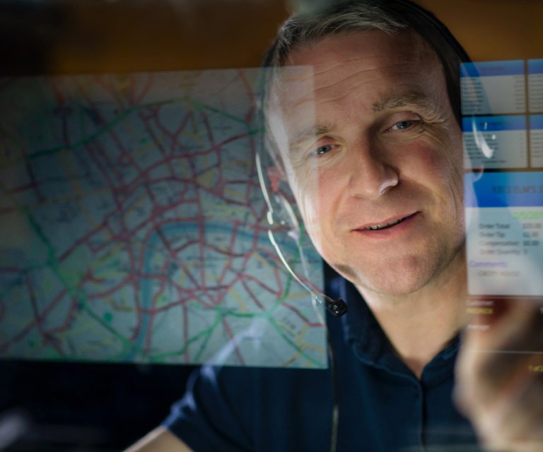 Man in headphones looking at computer screen