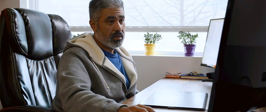 Adrian Gonzalez, Ronin Design Co. co-founder, sitting at his desk