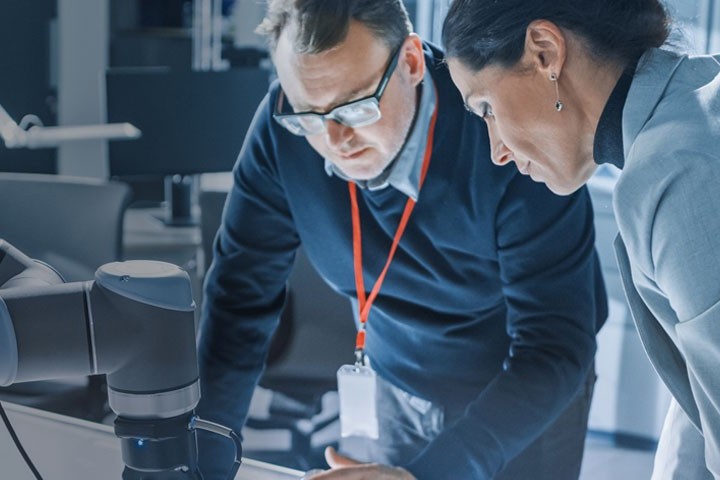 Two colleagues testing lab samples with a digital microscope