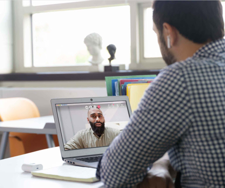 Two educators on a video call in a classroom