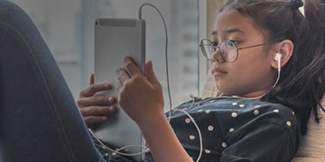 k 12 girl with tablet earphones