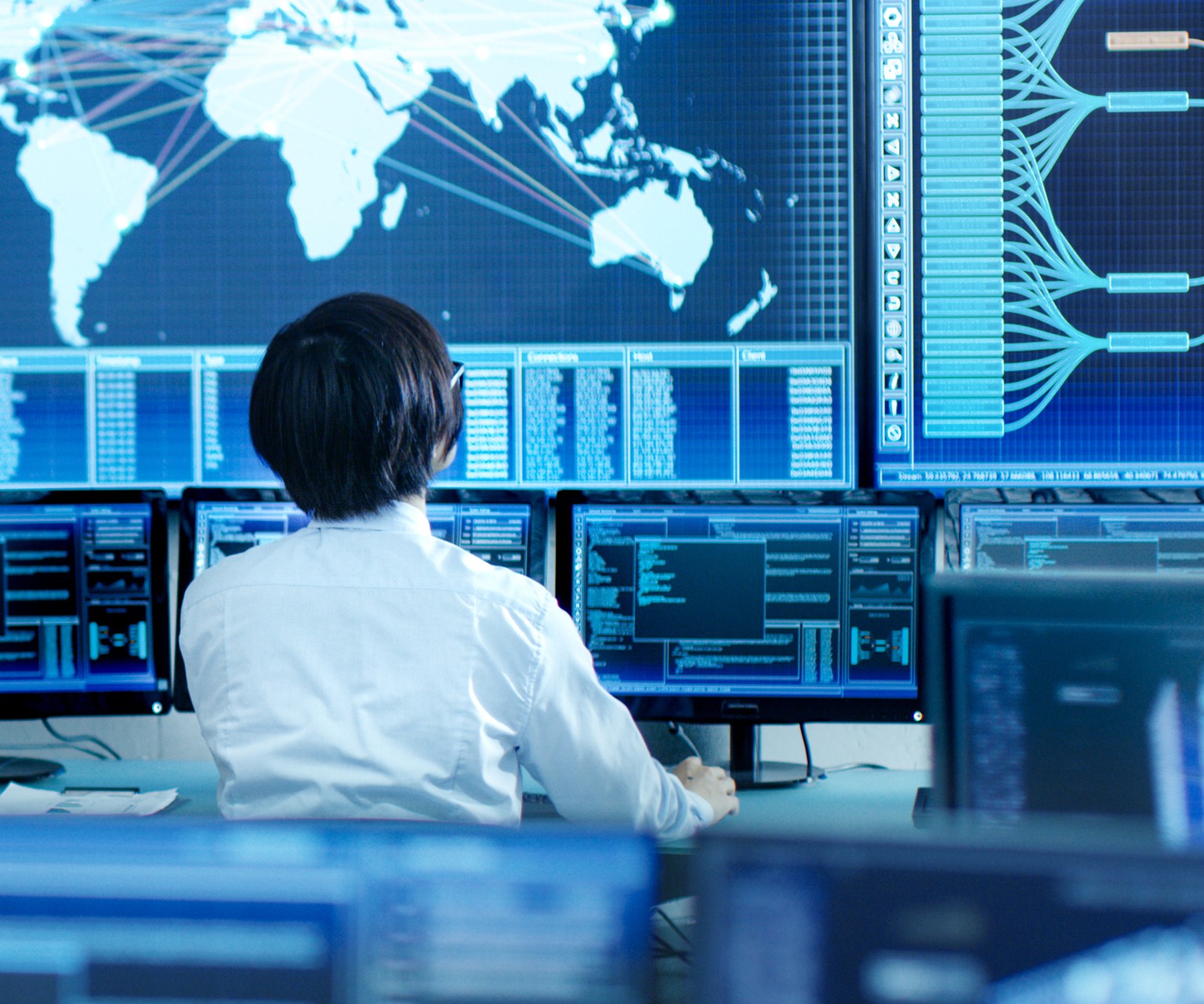 Person looking at various screens at a workstation