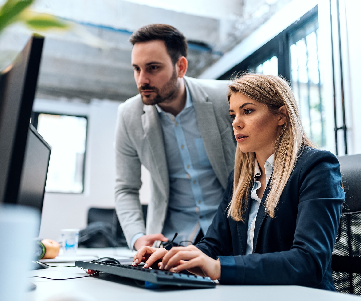 Man and woman looking at a computer