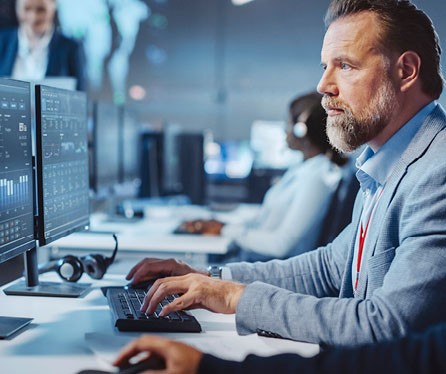 Man at work looking at a monitor