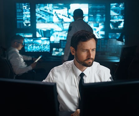 Man in front of monitors