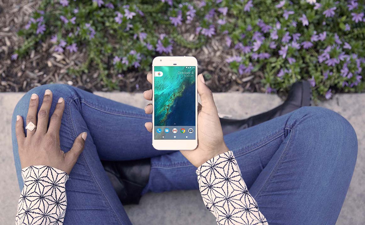 sitting on a pavement holding a mobile