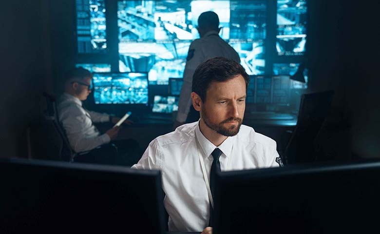 a man with beard in a dark computer room