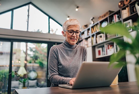 a woman talking at a laptop