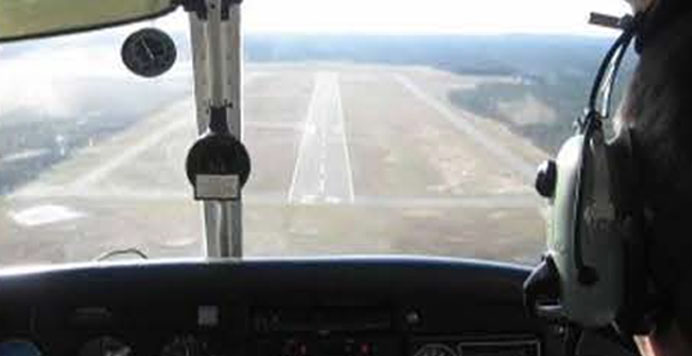 A pilot with headset overlooking a ground 