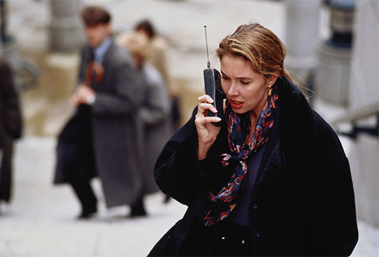 a woman holding an old cell phone