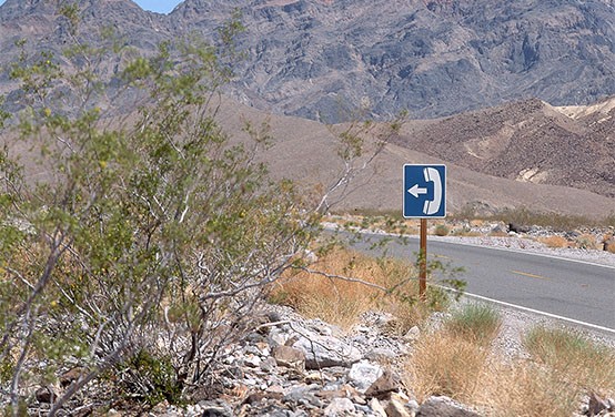 a telephone sign post on a rural road
