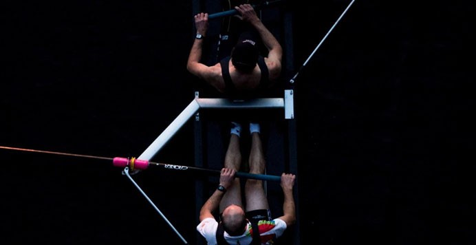 Men rowing a boat machine