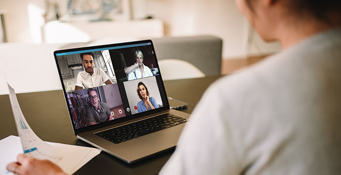 A woman having online meeting with four people
