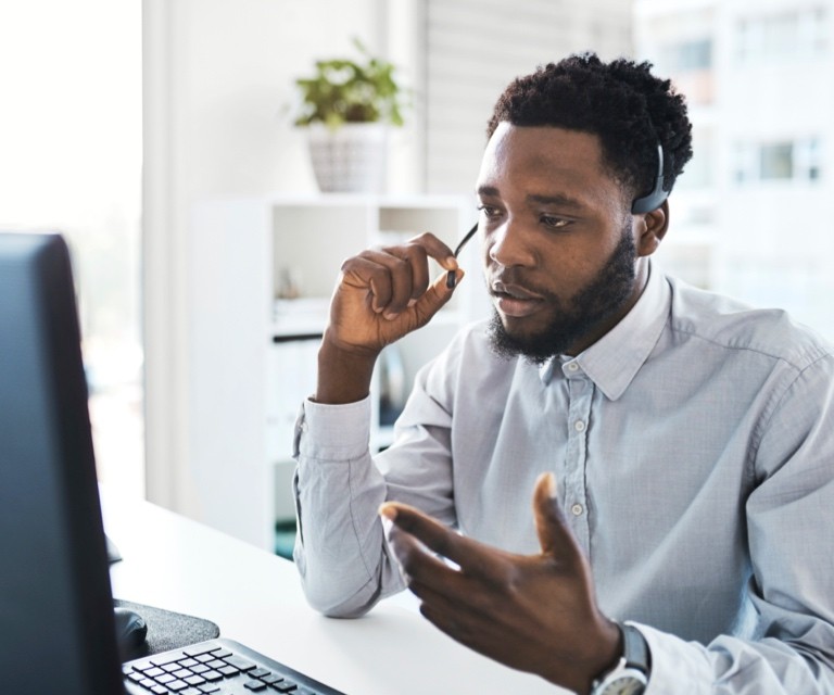 man talking on conference call wearing a headset