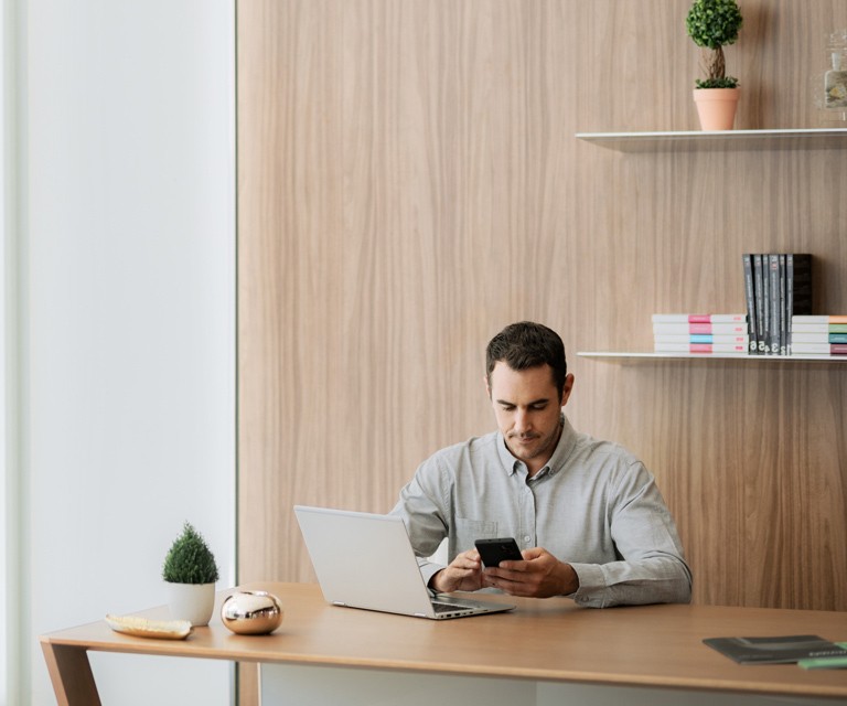 Man using smartphone while sitting at desk